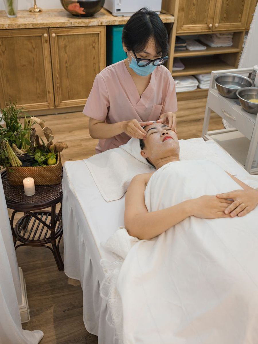 Esthetician performing a facial treatment